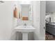 The bathroom features a pedestal sink, neutral decor, and is located near the kitchen and living room at 3003 Salix Bend Dr, Charlotte, NC 28205