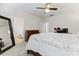 Bedroom with ceiling fan, large dresser, mirror and view into attached bathroom at 3003 Salix Bend Dr, Charlotte, NC 28205