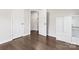 Bedroom featuring wood floors, white doors, and a minimalist white cabinet at 3003 Salix Bend Dr, Charlotte, NC 28205