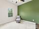 Cozy bedroom featuring a chair, accent wall, and a bright window with outdoor views at 3003 Salix Bend Dr, Charlotte, NC 28205