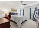 The bedroom has a ceiling fan, a large bed, and two windows at 3003 Salix Bend Dr, Charlotte, NC 28205
