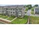 Exterior view of townhomes with well-maintained lawns and a community green space at 3003 Salix Bend Dr, Charlotte, NC 28205