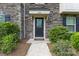 Charming front entrance featuring stone facade, covered porch, and lush landscaping at 3003 Salix Bend Dr, Charlotte, NC 28205