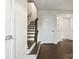 Hallway with wood floors, white trim, and staircase with wooden banister at 3003 Salix Bend Dr, Charlotte, NC 28205