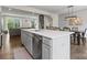 Open kitchen with stainless steel dishwasher, white cabinets, and adjacent dining area at 3003 Salix Bend Dr, Charlotte, NC 28205