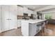Modern kitchen features stainless steel appliances, white cabinets, and a spacious island with barstool seating at 3003 Salix Bend Dr, Charlotte, NC 28205