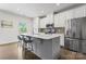 Modern kitchen with stainless steel appliances, island with breakfast bar, and white cabinets at 3003 Salix Bend Dr, Charlotte, NC 28205