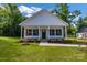 Charming home with a covered front porch, tidy landscaping, and classic white siding at 321 Whitner St, Rock Hill, SC 29732