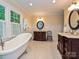 Updated bathroom with dual vanities, marble countertops, a soaking tub, and a separate shower at 4951 Dayspring Dr, Mint Hill, NC 28227