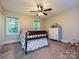 Cozy bedroom with natural light, ceiling fan, and vintage-style furniture at 4951 Dayspring Dr, Mint Hill, NC 28227
