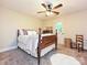 Comfortable bedroom with a wooden bed, neutral walls, and outdoor access through a door at 4951 Dayspring Dr, Mint Hill, NC 28227