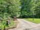 Welcoming driveway leading to a home, lush greenery on either side, and a mailbox at the entrance at 4951 Dayspring Dr, Mint Hill, NC 28227