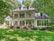 Charming two-story home with a double porch, black shutters, and a lush, well-maintained lawn at 4951 Dayspring Dr, Mint Hill, NC 28227