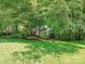 Charming two-story home with a lush lawn and surrounded by mature trees at 4951 Dayspring Dr, Mint Hill, NC 28227