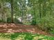 Traditional white home with double porches, framed by mature trees, offering privacy and curb appeal at 4951 Dayspring Dr, Mint Hill, NC 28227