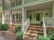 Inviting front porch with brick steps, white railings, and decorative plants, creating a warm welcome at 4951 Dayspring Dr, Mint Hill, NC 28227