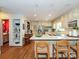 Bright kitchen featuring hardwood floors, stainless steel appliances, and an adjacent bathroom at 4951 Dayspring Dr, Mint Hill, NC 28227