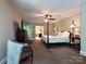 Large main bedroom featuring a king bed, neutral carpet, sitting area, and entry to the main bathroom at 4951 Dayspring Dr, Mint Hill, NC 28227