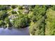Aerial view of a home and property nestled amongst lush trees and with views of the pond at 5183 Mill Race Ln, Lancaster, SC 29720