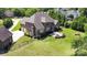 Aerial view of the property showcasing a large backyard with a fire pit, complemented by mature trees and landscaping at 5183 Mill Race Ln, Lancaster, SC 29720
