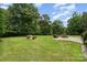 Large grassy backyard featuring a cozy fire pit area with stone pavers, perfect for outdoor entertaining at 5183 Mill Race Ln, Lancaster, SC 29720