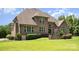 Expansive backyard with lush green grass, complemented by well-maintained landscaping around the brick home at 5183 Mill Race Ln, Lancaster, SC 29720