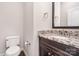 A cozy half-bath featuring a granite countertop and classic fixtures at 5183 Mill Race Ln, Lancaster, SC 29720