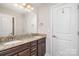 Bathroom featuring a double sink vanity with granite counters and a large mirror, plus convenient storage at 5183 Mill Race Ln, Lancaster, SC 29720