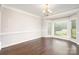Bright dining room with large bay windows, hardwood floors and elegant chandelier at 5183 Mill Race Ln, Lancaster, SC 29720