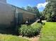 Back exterior with brick, deck and beautiful landscaping with greenery in the backyard at 5495 Valley Run St, Hickory, NC 28601