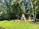 Backyard featuring a unique A-frame shed surrounded by trees, ideal for storage or a workshop at 5495 Valley Run St, Hickory, NC 28601