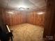Basement with wood paneling, neutral carpet, and ample space for various activities at 5495 Valley Run St, Hickory, NC 28601