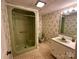 Bathroom featuring a retro green tub, matching toilet, and a vanity with patterned wallpaper at 5495 Valley Run St, Hickory, NC 28601