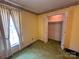 Bedroom featuring a closet and a window letting in natural light to illuminate the green carpet at 5495 Valley Run St, Hickory, NC 28601