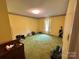 Spacious bedroom with green carpet, floral wallpaper border, and a window with light-filtering curtains at 5495 Valley Run St, Hickory, NC 28601