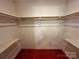 Walk-in closet with carpeted floor and wooden shelves and rod for hanging clothes at 5495 Valley Run St, Hickory, NC 28601