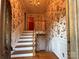 Entryway with staircase featuring floral wallpaper and painted white trim at 5495 Valley Run St, Hickory, NC 28601