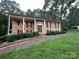 Charming brick home with manicured landscaping and a covered porch supported by columns at 5495 Valley Run St, Hickory, NC 28601