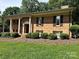 Charming brick facade with a covered porch, manicured landscaping and an inviting entrance at 5495 Valley Run St, Hickory, NC 28601