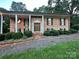 Charming brick home with a well-manicured lawn and inviting front porch with columns at 5495 Valley Run St, Hickory, NC 28601