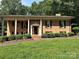 Charming brick home with well-manicured lawn, pillared porch, and mature landscaping at 5495 Valley Run St, Hickory, NC 28601