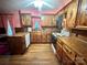 A functional kitchen space equipped with wood cabinets and red accents and light-colored appliances at 5495 Valley Run St, Hickory, NC 28601