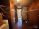 Laundry room featuring wood paneling, storage shelves, brick-look tile, with a washer and dryer at 5495 Valley Run St, Hickory, NC 28601