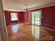 Bright living room featuring hardwood floors, two chandeliers and large windows to the porch at 5495 Valley Run St, Hickory, NC 28601