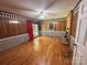 Living room with wood paneling, brick fireplace, hardwood floors, and diamond patterned wallpaper at 5495 Valley Run St, Hickory, NC 28601