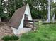 A-frame style shed with wooden deck and wooded surroundings in the backyard at 5495 Valley Run St, Hickory, NC 28601