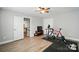 Bedroom showcasing light gray walls, a ceiling fan, light wood-look floors, and an open doorway at 5723 Notch Peak Ave, Indian Land, SC 29707