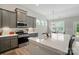 Modern kitchen with stainless appliances and island seating, seamlessly connecting to the dining area at 5723 Notch Peak Ave, Indian Land, SC 29707