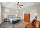 Serene main bedroom features a tray ceiling, fan, and hardwood floors at 5723 Notch Peak Ave, Indian Land, SC 29707