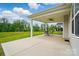 Covered patio with an outdoor dining set, offering a relaxing view of the lush backyard and landscaping at 5723 Notch Peak Ave, Indian Land, SC 29707